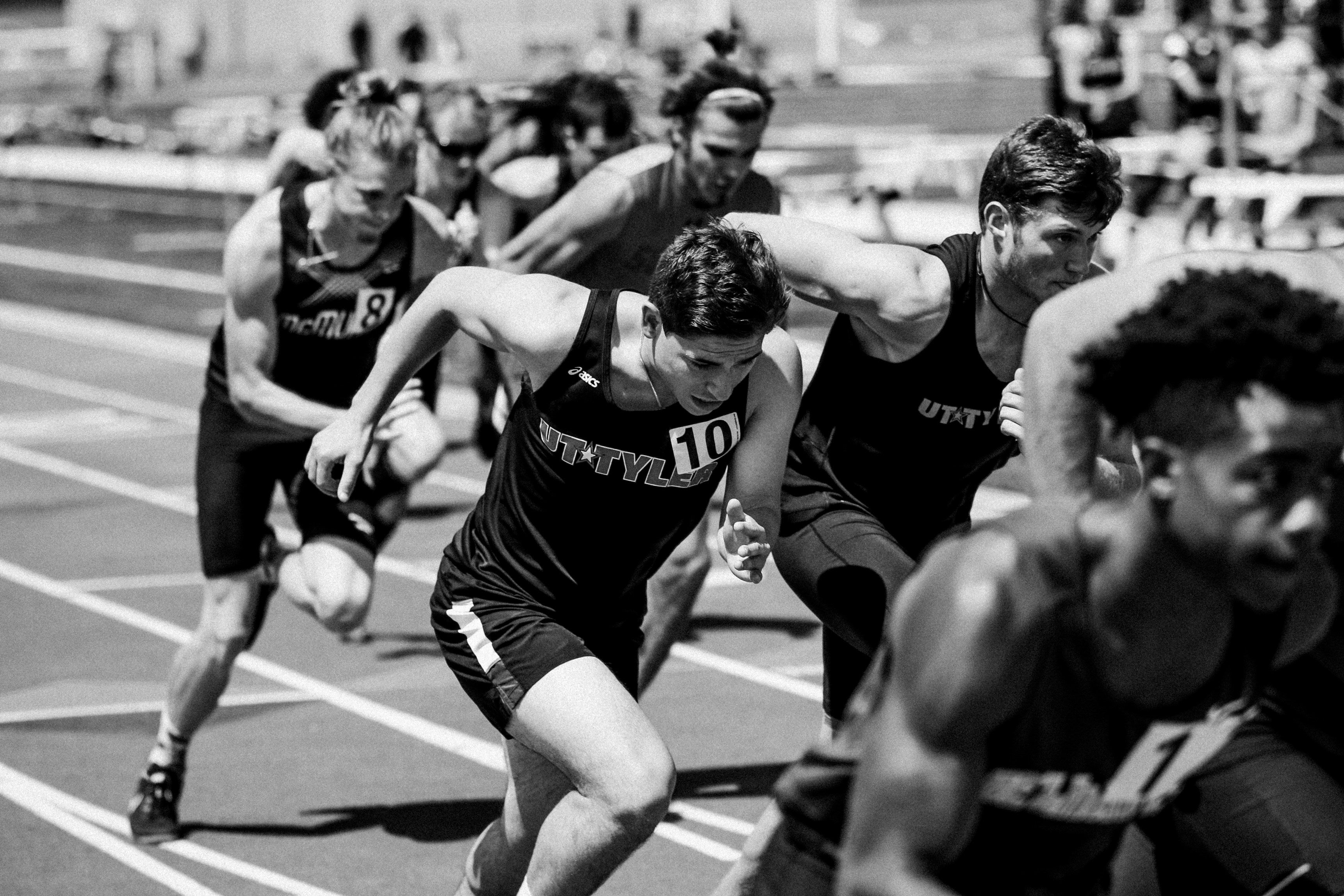 Athletes in a starting position on a track, likely preparing for a race.